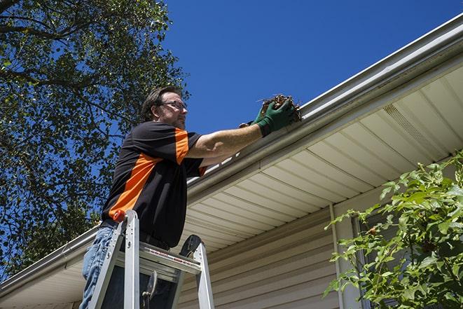 skilled technician fixing damaged gutters in Hazelwood